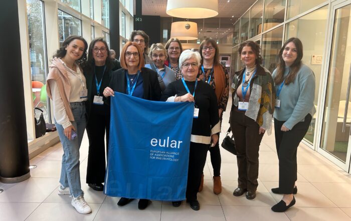 The SQUEEZE patient research partners holding up a EULAR flag